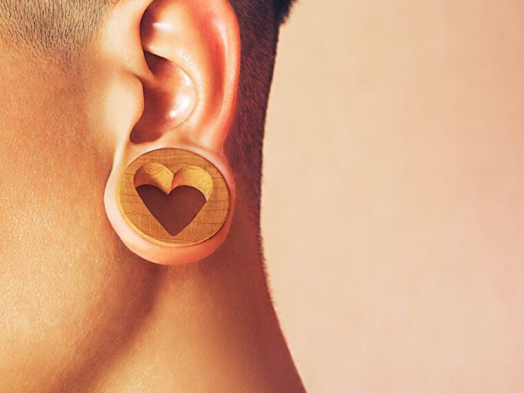 Woman wearing a wooden earring with a heart