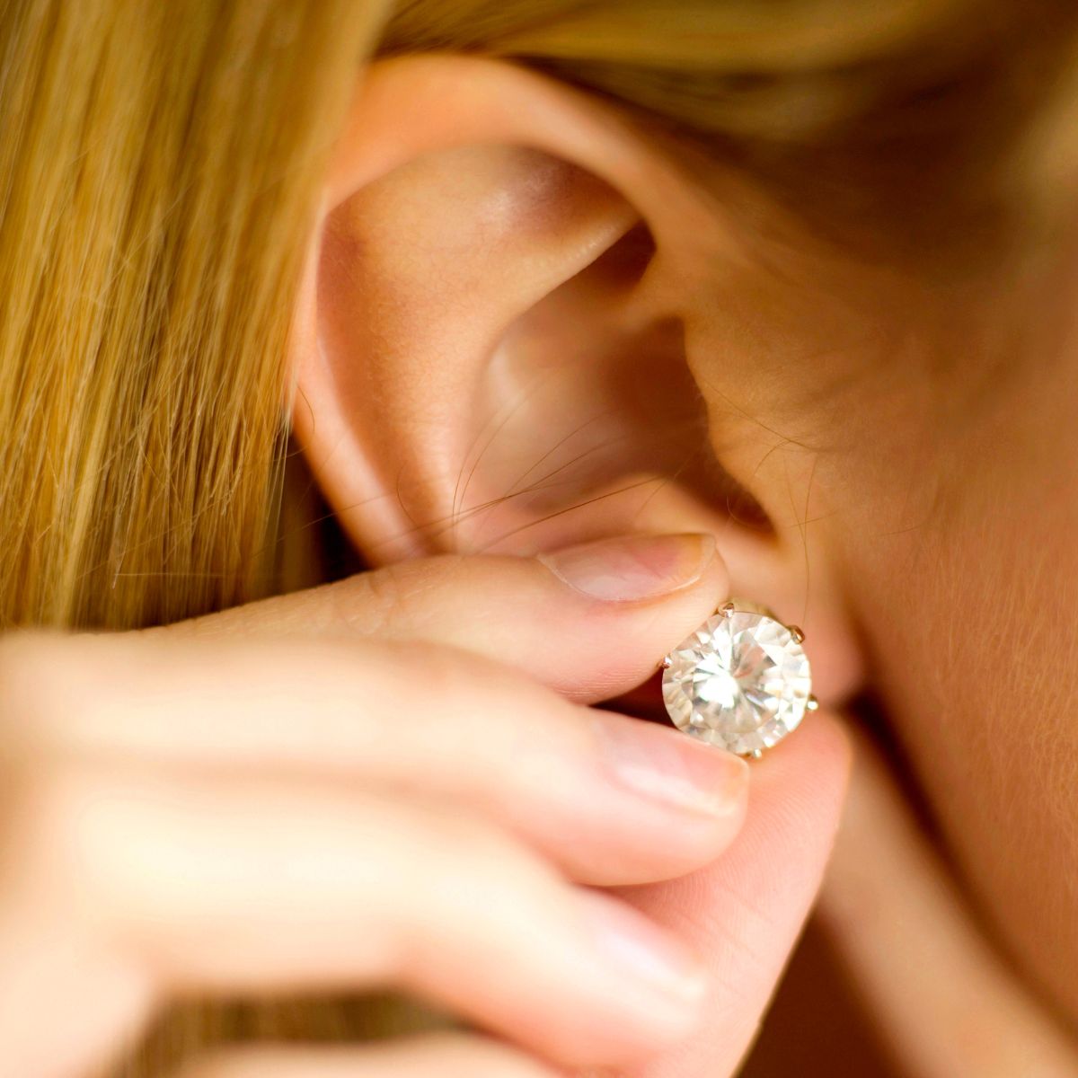 Girl holding diamond earring