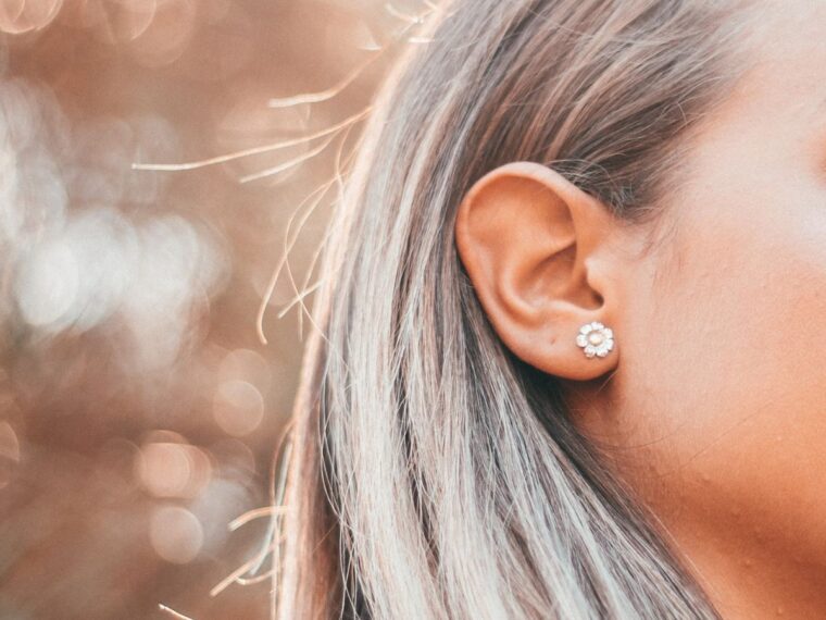 Girl with silver hair wearing a diamond stud earring