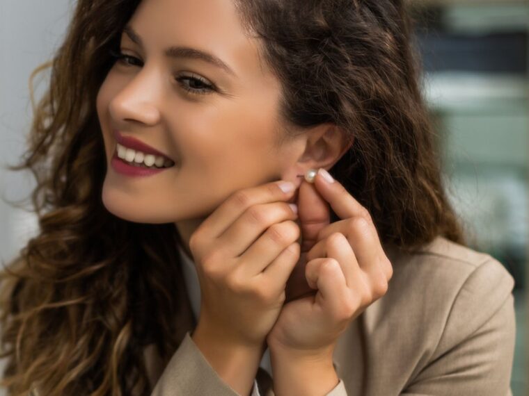 girl taking out earrings